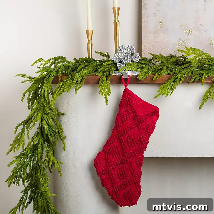 Norfolk Pine Natural Touch Garland from Kirklands, showcasing a dense, realistic texture with a hint of frosted tips.