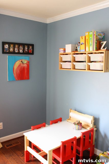Practical Playroom Storage Solutions Vertical shot of playroom with storage, bean bags, and wall art