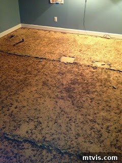 The Ultimate Playroom Unveiled 7 Joe working on removing the old carpet and padding