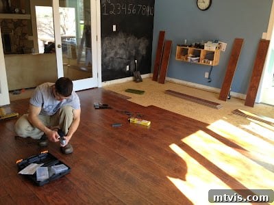 The Ultimate Playroom Unveiled 9 Installing the new hand-scraped laminate flooring in the playroom
