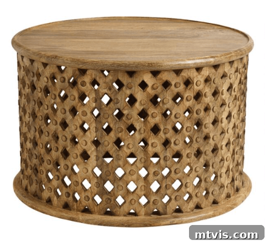World Market round carved lattice coffee table, a decorative rustic wood piece with unique openwork design