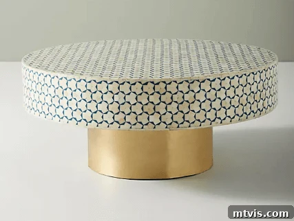 Anthropologie Targua inlay coffee table, featuring an intricate pattern and elegant gold base for a luxurious living space
