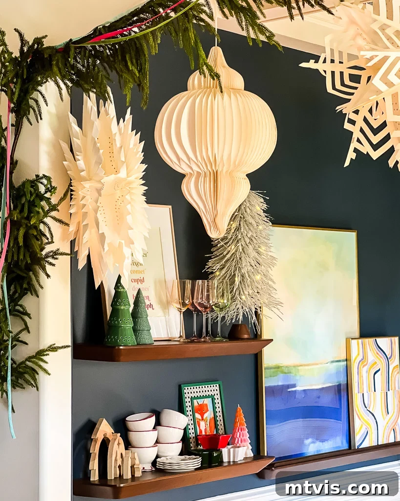 Dining room decorated for Christmas, featuring festive paper lanterns and elegant holiday dishware on display.
