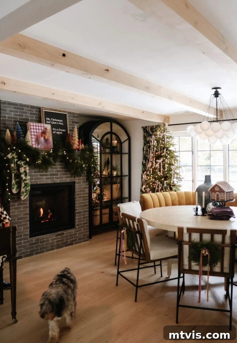 Christmas decorations in a dining room, featuring a festive tree and a cozy fireplace adorned with garlands and lights.