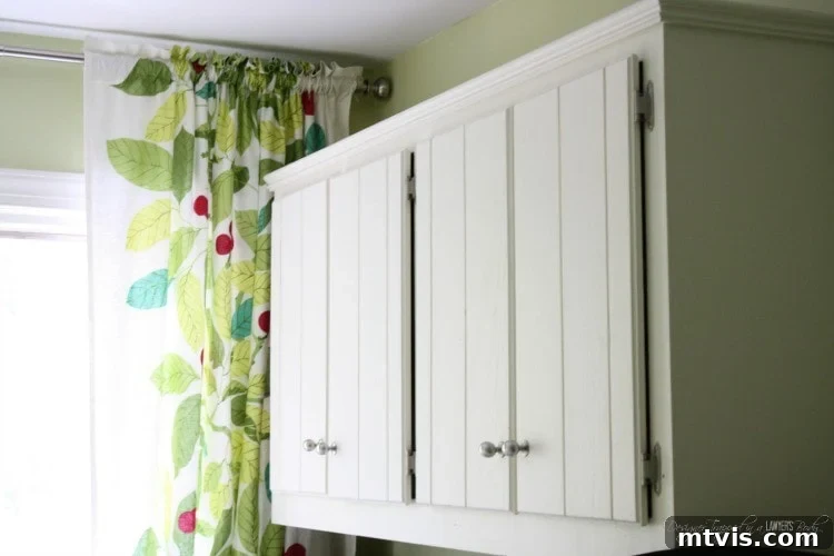 Close-up of the newly painted cabinets and countertop in the DIY laundry room makeover.