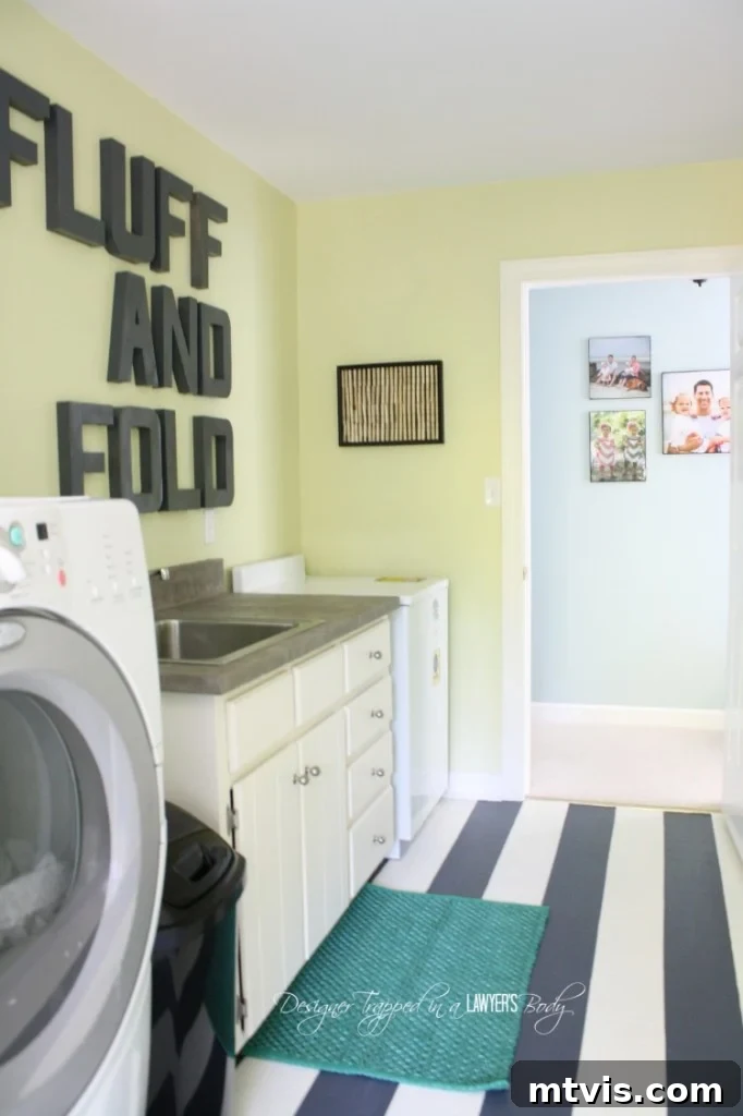 Stylish details and decor within the budget-friendly renovated laundry room.