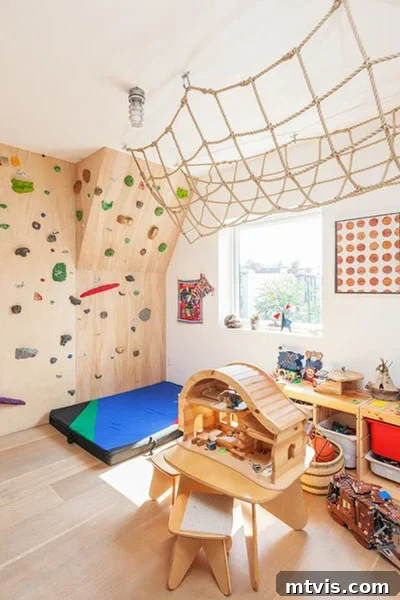 Playful and Chic Playroom Design Guide 25 An indoor gym playroom idea includes a rock-climbing wall, ceiling rope net and wooden toys and storage bins.
