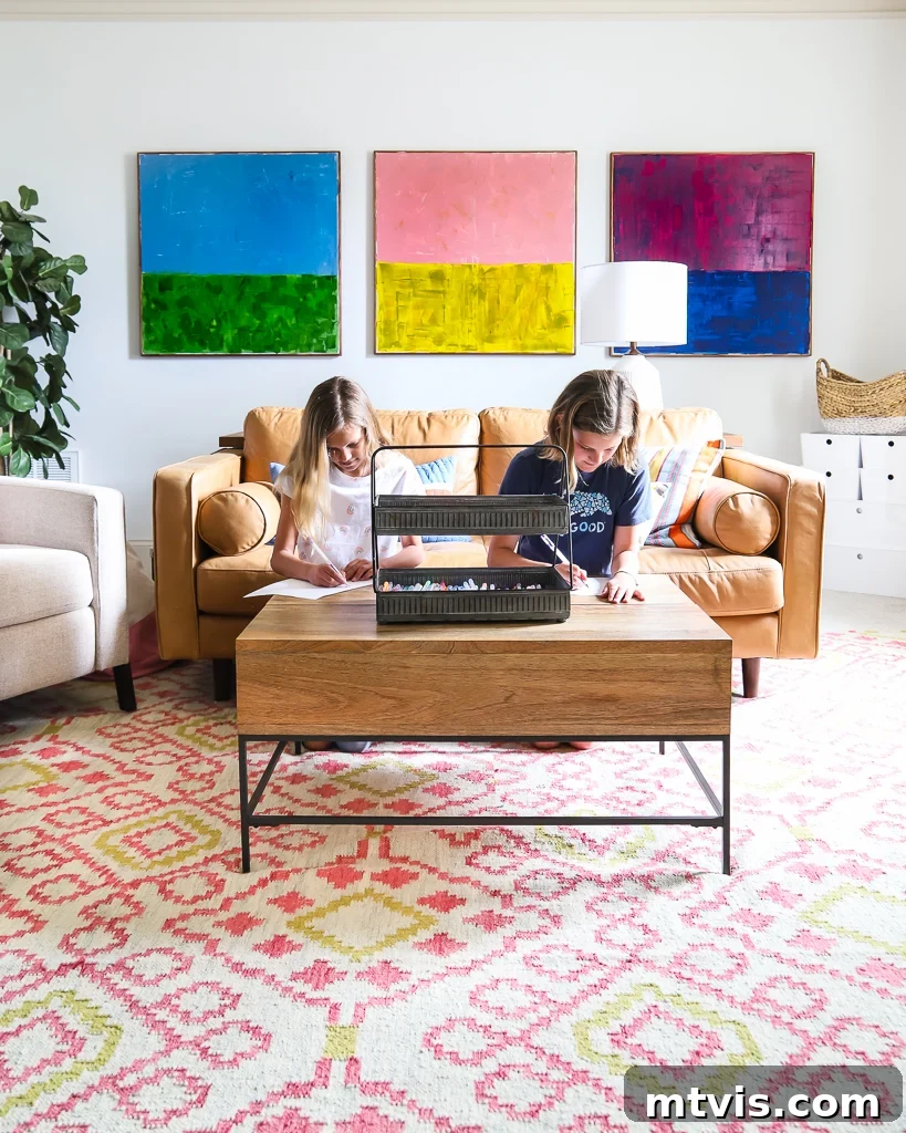 Playful and Chic Playroom Design Guide 4 A basic teen bonus room with colorful art squares, storage. and two tweens using the coffee table for writing. Tasha Agruso of Kaleidoscope Living designed this room.