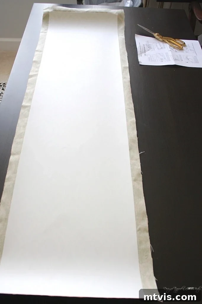 Trimming excess fabric, maintaining a 1/2-inch overhang on three sides