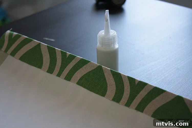 Folding and gluing the fabric overhang on one short end of the styrene