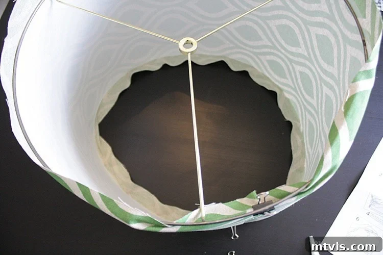 Securing the top lampshade ring with binder clips for drum shade assembly
