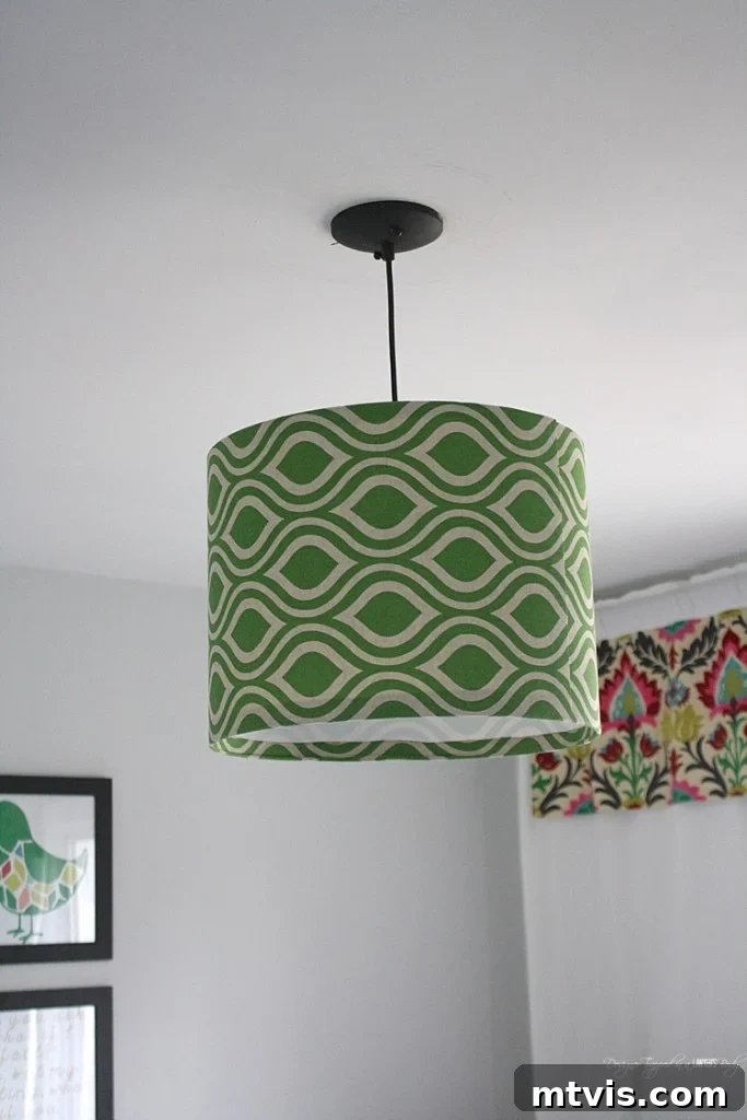 Close-up of a handmade fabric drum pendant light, showcasing unique fabric pattern