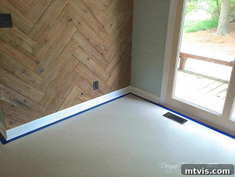 Taping the perimeter with painter's tape creates a neat border for your stenciled floors. This step is optional, but it defines the stencil area and provides a crisp, finished edge to your design, particularly around baseboards.
