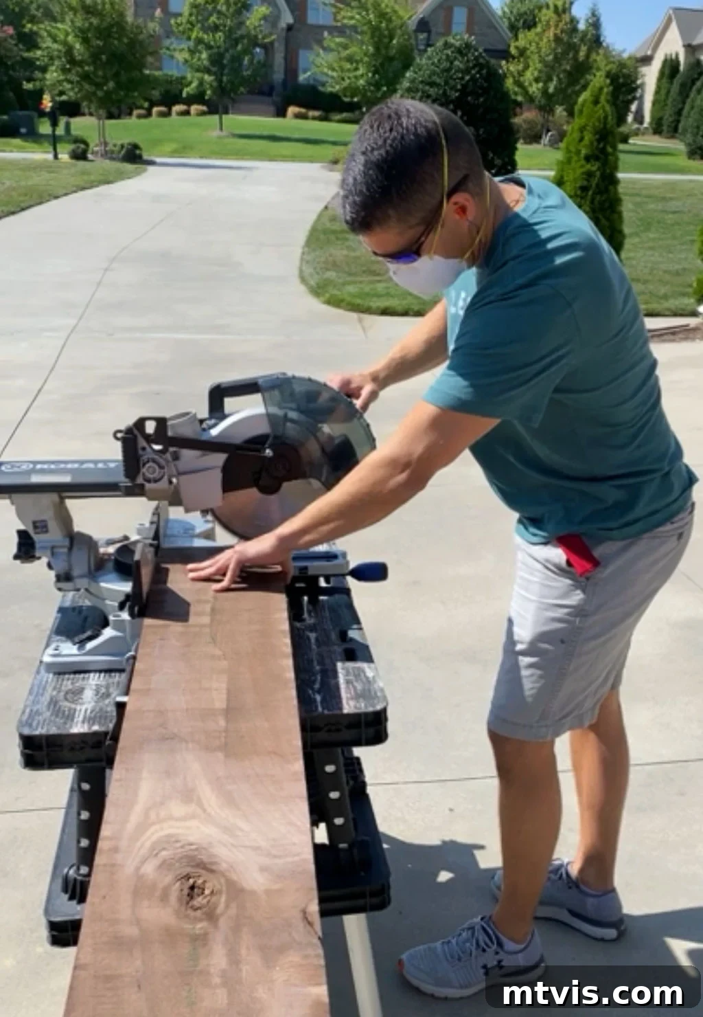 A person precisely cutting a wooden board to the desired length for DIY wall shelves using a miter saw.