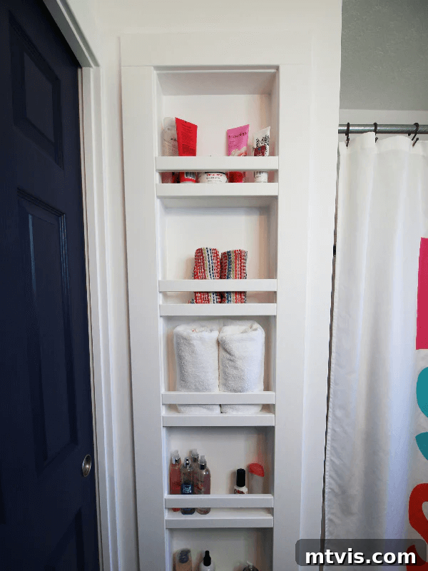 DIY built-in niche between wall studs in a bathroom for towel and toiletry storage