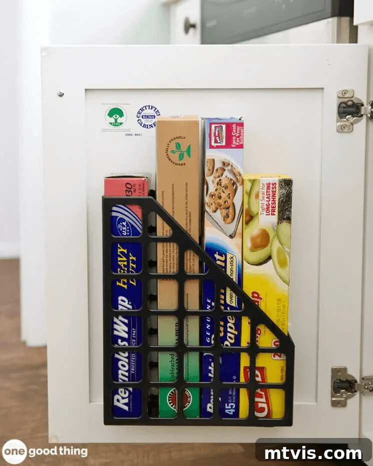 Magazine holder attached to inside of cabinet door for food wraps and bags