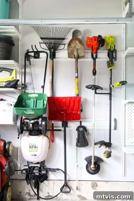 Wall track system neatly organizing various yard tools