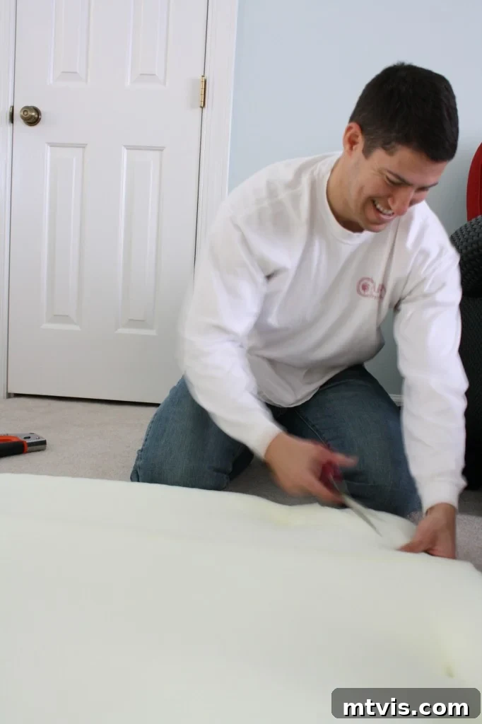 Custom Upholstered Headboard Project 8 Trimming excess egg crate foam to match the headboard's custom shape.