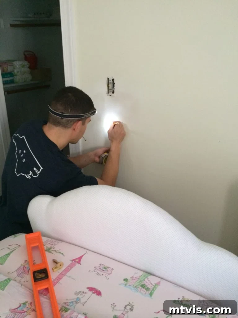 Custom Upholstered Headboard Project 15 Installing D-rings on the back of the headboard for secure wall mounting.