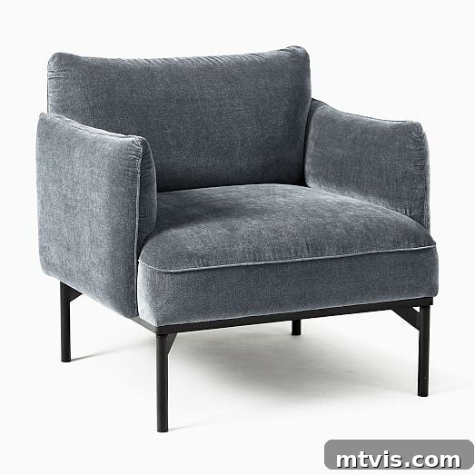 Score Stylish Accent Chairs on a Budget 10 A sophisticated blue-gray velvet accent chair from West Elm, priced under $400, adding luxury to any space.