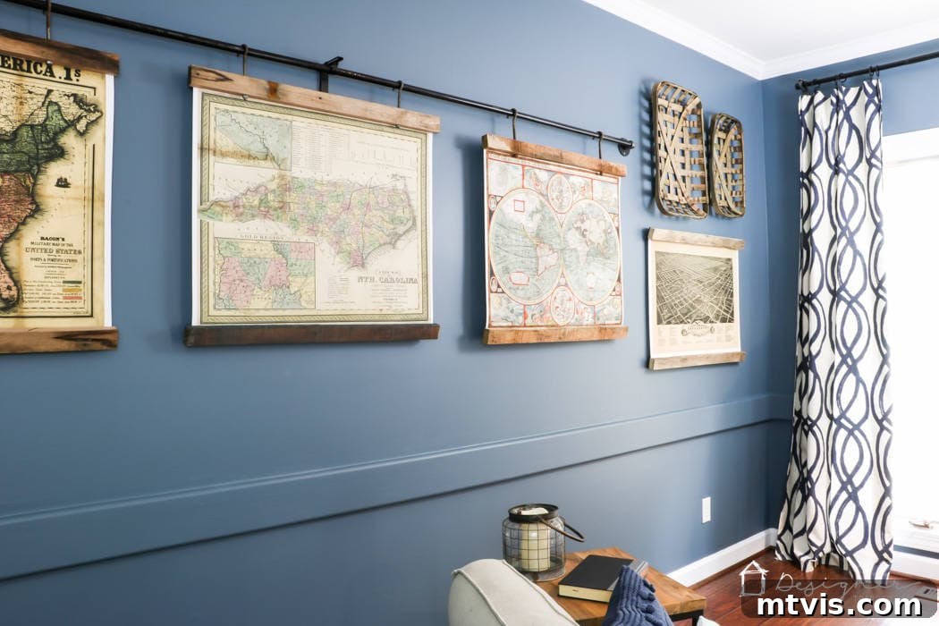Sophisticated Serenity: Top Blue-Gray Paint Colors 6 Philipsburg Blue by Benjamin Moore on the family room wall of Tasha Agruso of Kaleidoscope Living. Ancient maps on an industrial pole decorate the wall.
