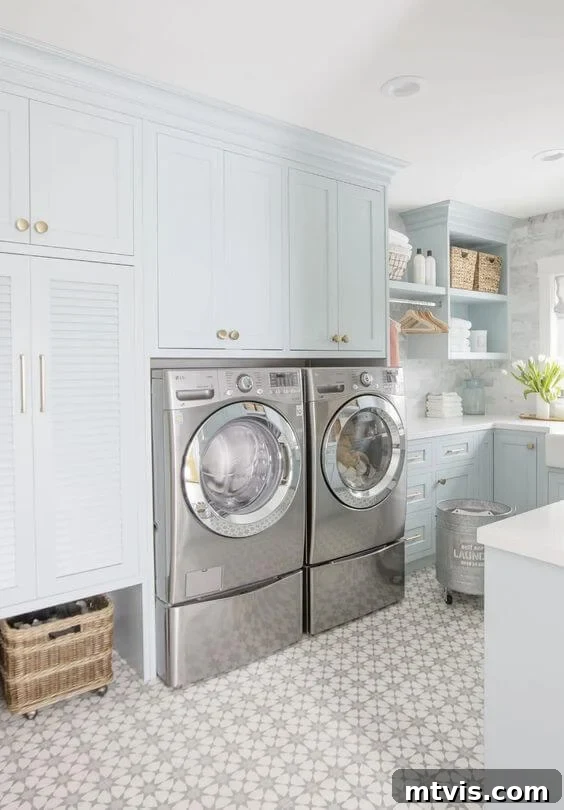 Sophisticated Serenity: Top Blue-Gray Paint Colors 7 A very pale blue gray laundry room with cabinets, shelves, and a stainless steel washer and dryer.