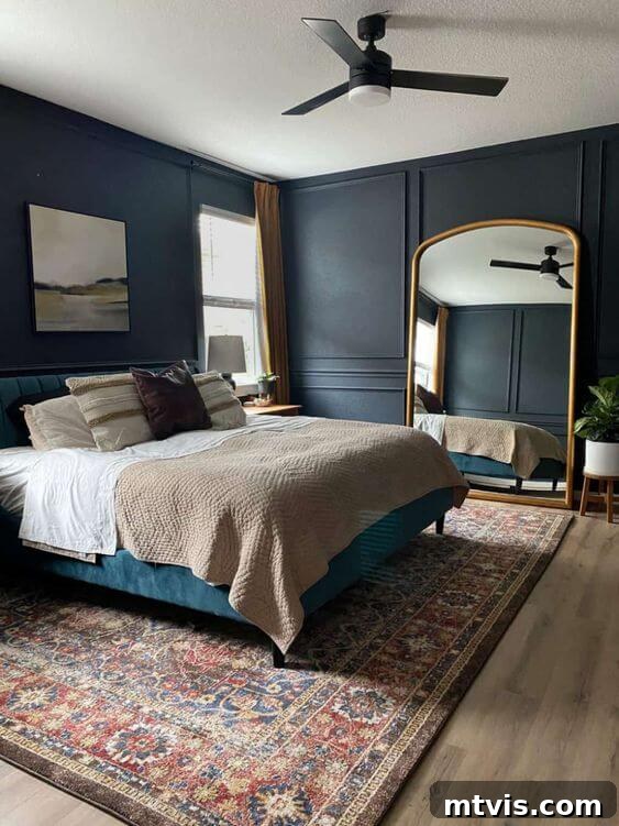 Sophisticated Serenity: Top Blue-Gray Paint Colors 8 A bedroom with a giant gold mirror and bed has dark walls using blue gray paint colors.