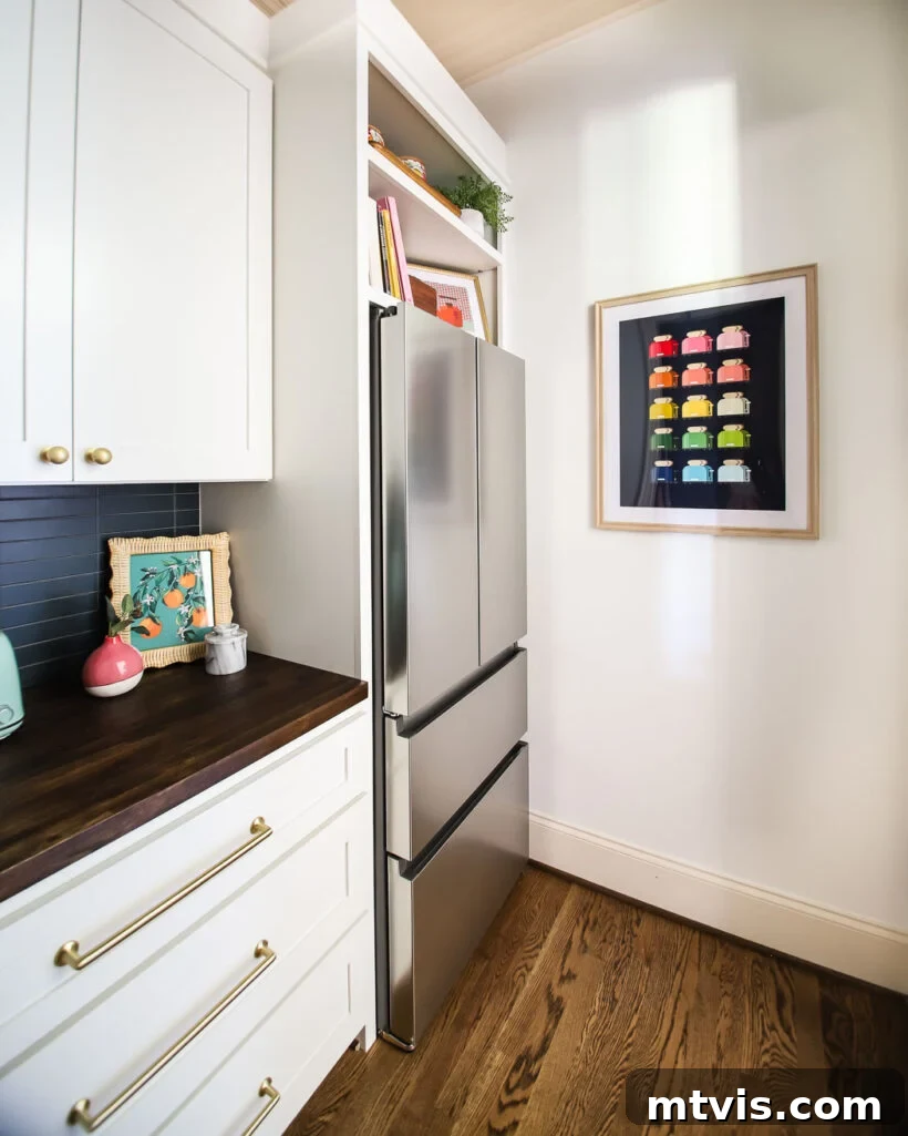 Bright and organized butler's pantry with a secondary refrigerator and elegant finishes.