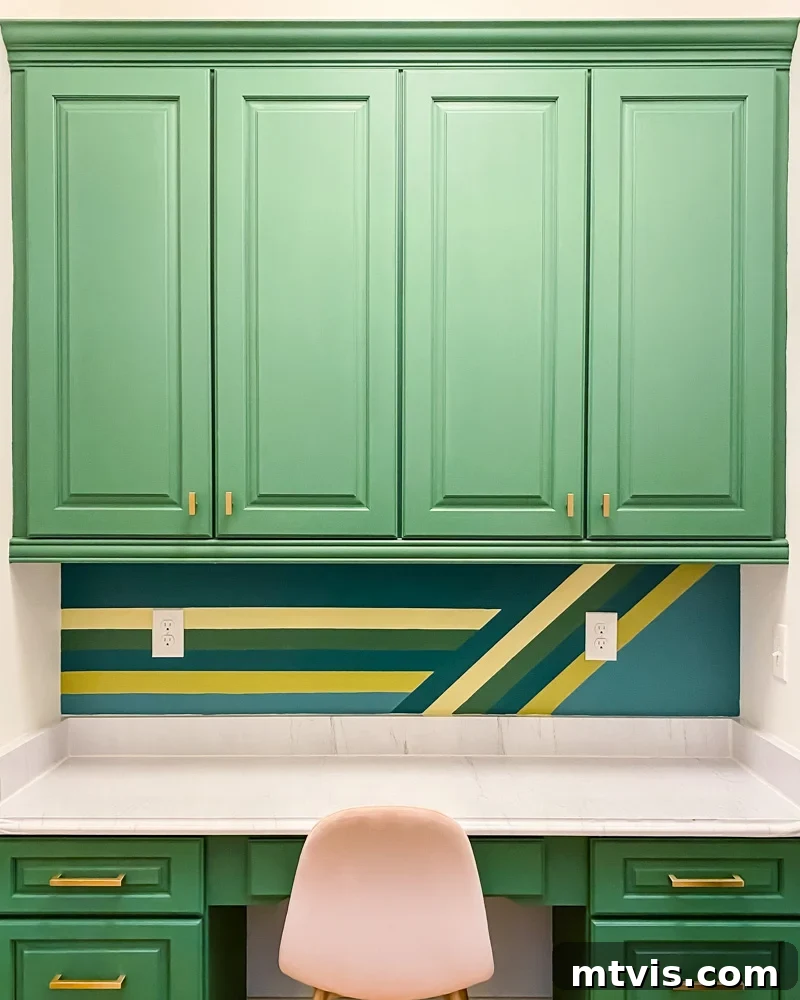After a cosmetic makeover, the built-in desk with updated paint and faux marble countertop.