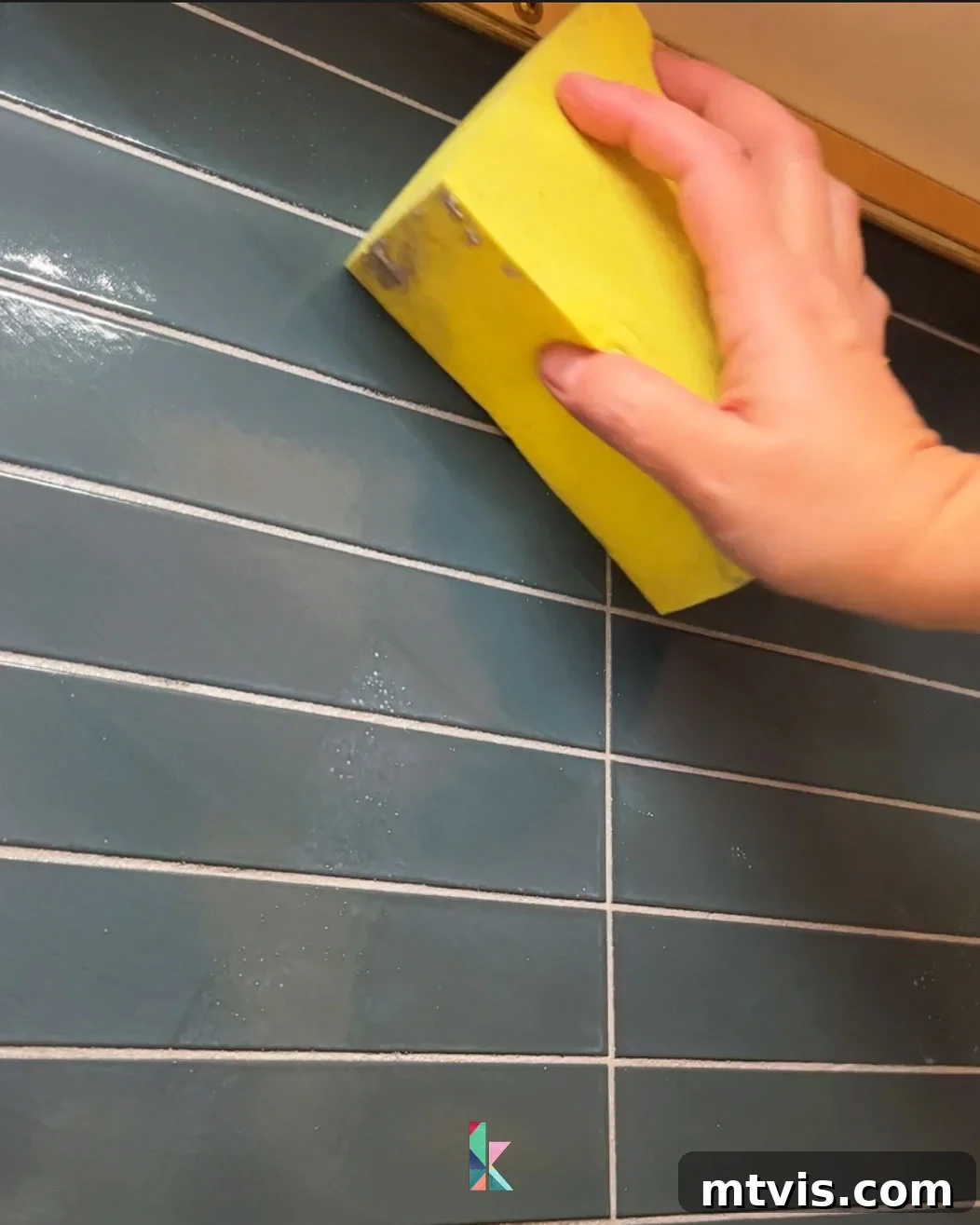 Installing a Tile Backsplash Made Simple 8 wiping excess grout off of backsplash tile
