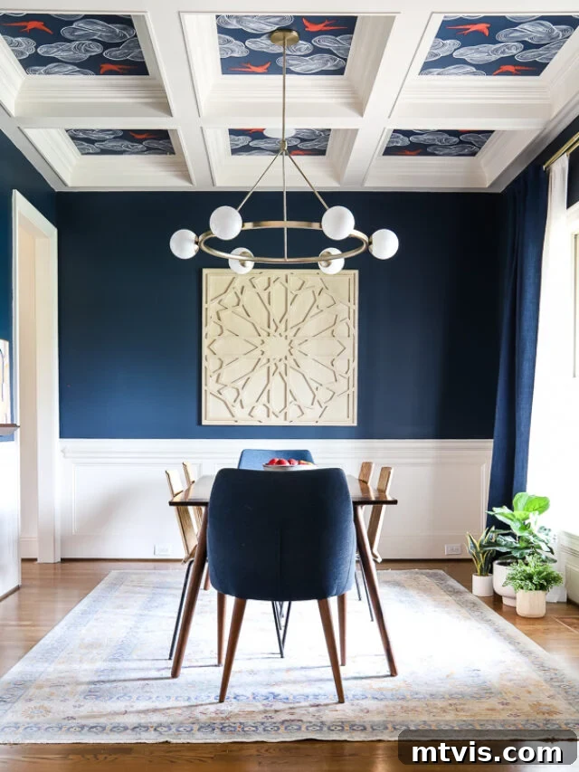 Designer-Approved Navy Blue Hues 6 A dining room painted with Sherman Williams Gale Force navy blue color with white wainscoting, wood floor and minimalist dining room table and chairs.