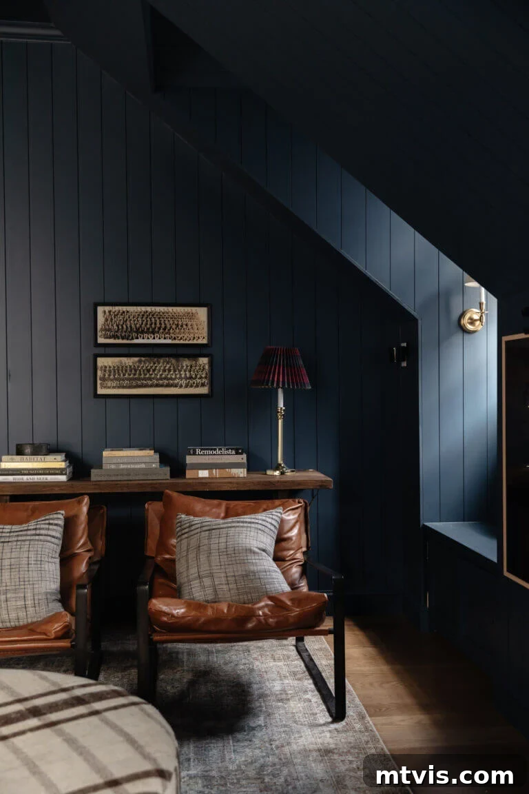 Designer-Approved Navy Blue Hues 10 Stiffkey navy blue paint color on the office walls and dormer of a bonus room with leather chairs and a slim desk.
