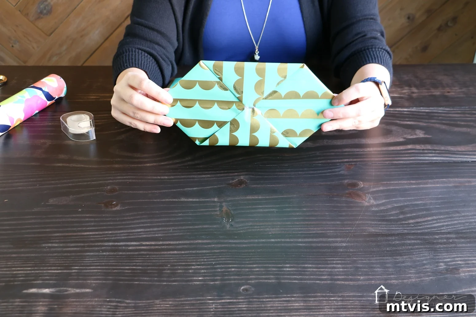 Upcycle Wrapping Paper into Custom Gift Bags 7 Taping the folded diamond to secure the bottom of the DIY gift bag