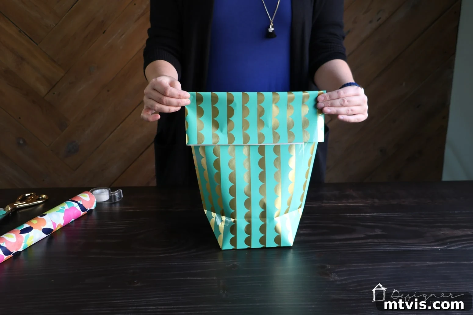 Upcycle Wrapping Paper into Custom Gift Bags 8 Folding the top of the gift bag and punching holes for ribbon handles