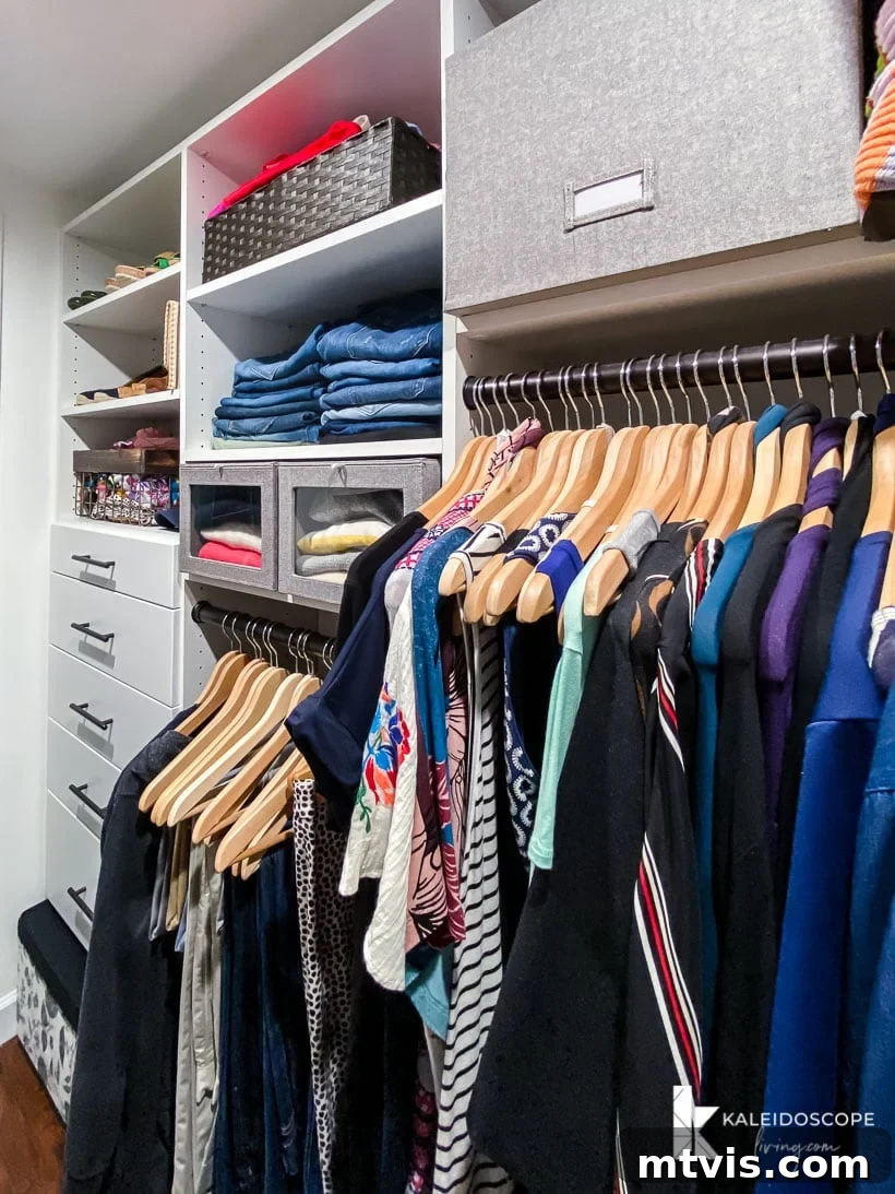 Transform Your Closets: 7 DIY Makeovers and Our Go-To Systems 4 One side of the primary bedroom closet has organized hanging clothes on different levels, drawers, and shelves using the EasyCloset system.