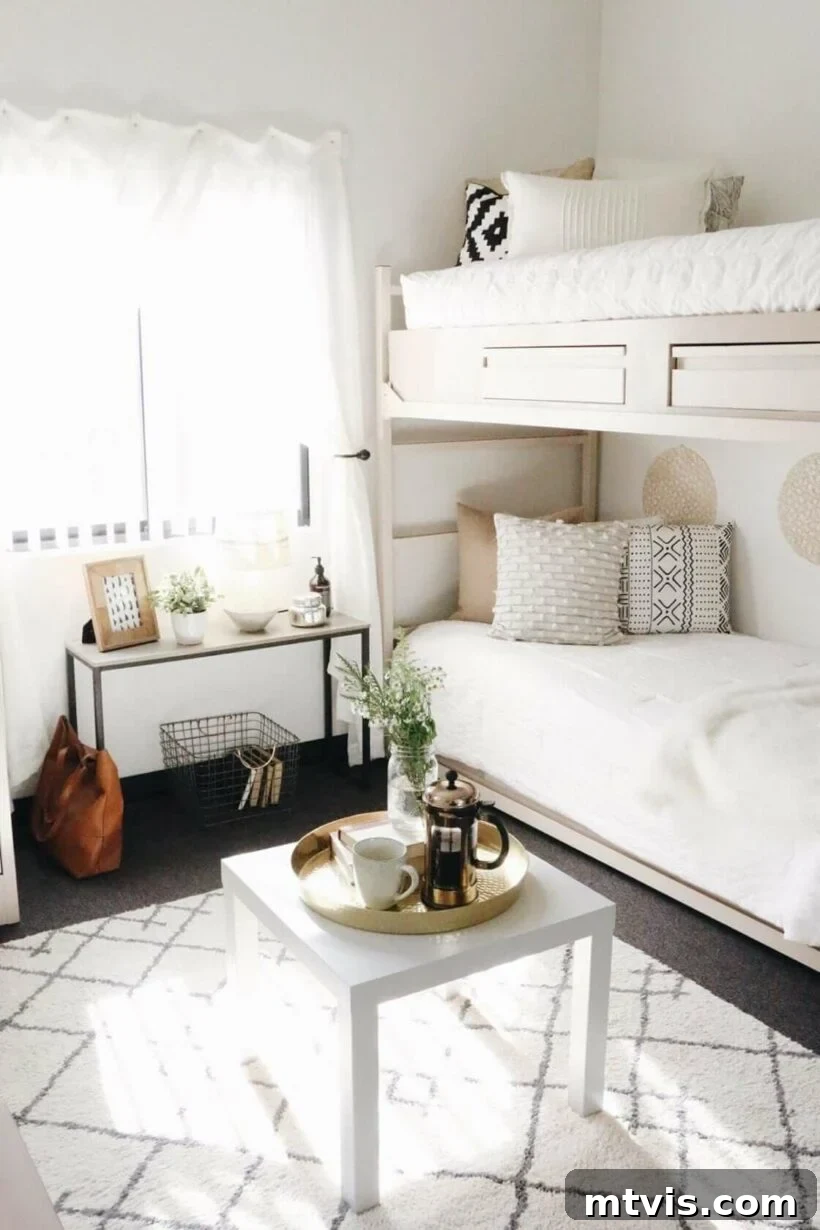 Ultimate Dorm Room Style Ideas and Shopping Sources 15 A black and white boho-chic dorm room idea featuring a bunk bed adorned with white and neutral bedding. The design includes a slim table positioned under the window and a square coffee table, creating a minimalist yet inviting student living space with a focus on natural textures and clean lines.