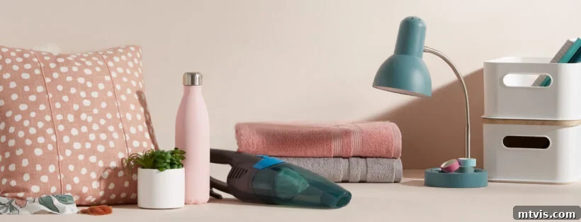 Ultimate Dorm Room Style Ideas and Shopping Sources 5 A tastefully arranged neutral-toned desk featuring dorm room ideas from Walmart. The setup includes a modern sage-colored dorm lamp, neatly folded neutral towels, a sleek water bottle, a small potted plant, white storage bins, and various other essential items for a functional and stylish dorm room.