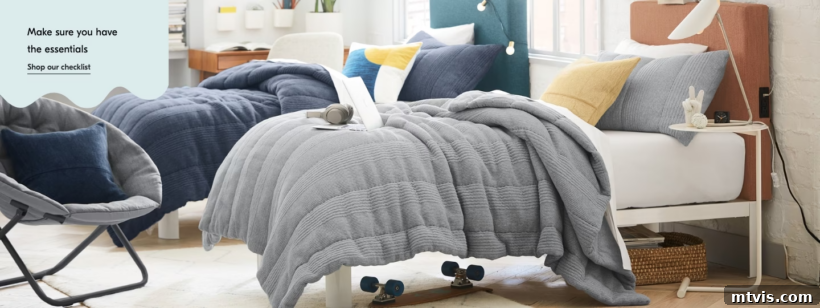Ultimate Dorm Room Style Ideas and Shopping Sources 9 West Elm's dorm room ideas feature a chic twin bed with serene blue-toned bedding, accompanied by a comfortable gray bucket chair. The minimalist aesthetic includes sparse nightstands, emphasizing functionality and modern style. A text overlay suggests,
