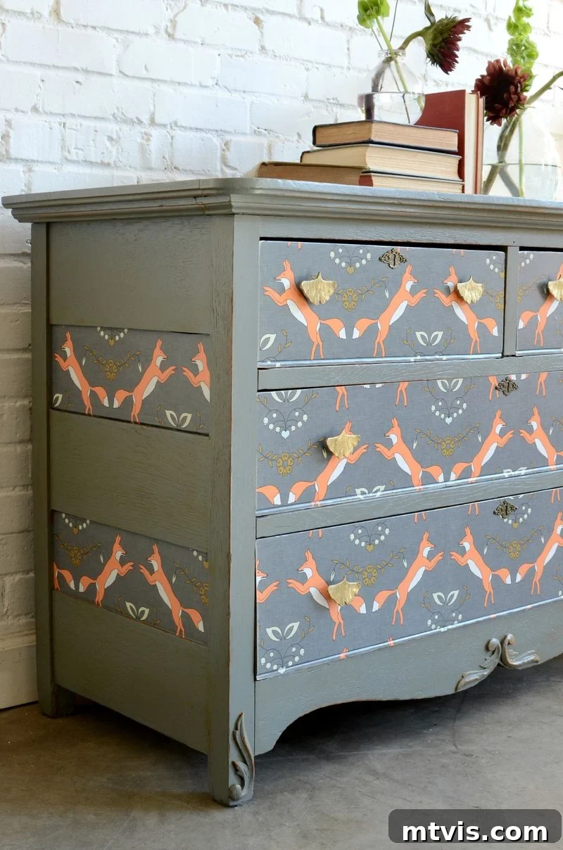 A kid's dresser with wallpapered drawer fronts, showcasing a fun and easily changeable decor idea for children's bedrooms.
