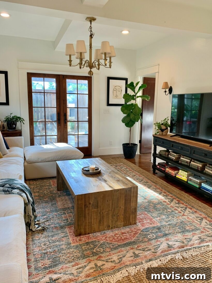 Mastering Living Room Rug Sizes 12 living room with a smaller area rug layered on top of a larger jute rug so that the overall area rug is large enough for the space