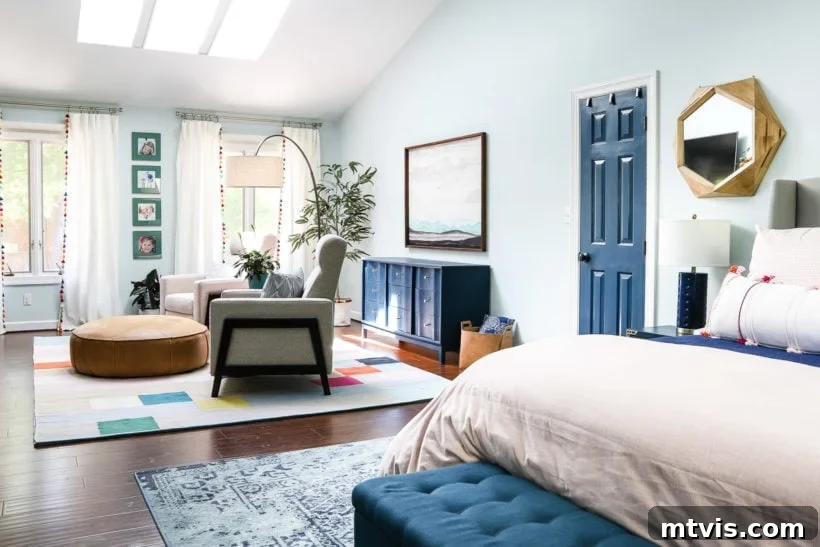 Perfecting Your Bedroom: The Complete Rug Size and Placement Guide 3 A spacious primary bedroom featuring two area rugs, one beneath the king-size bed and another defining the cozy sitting area.