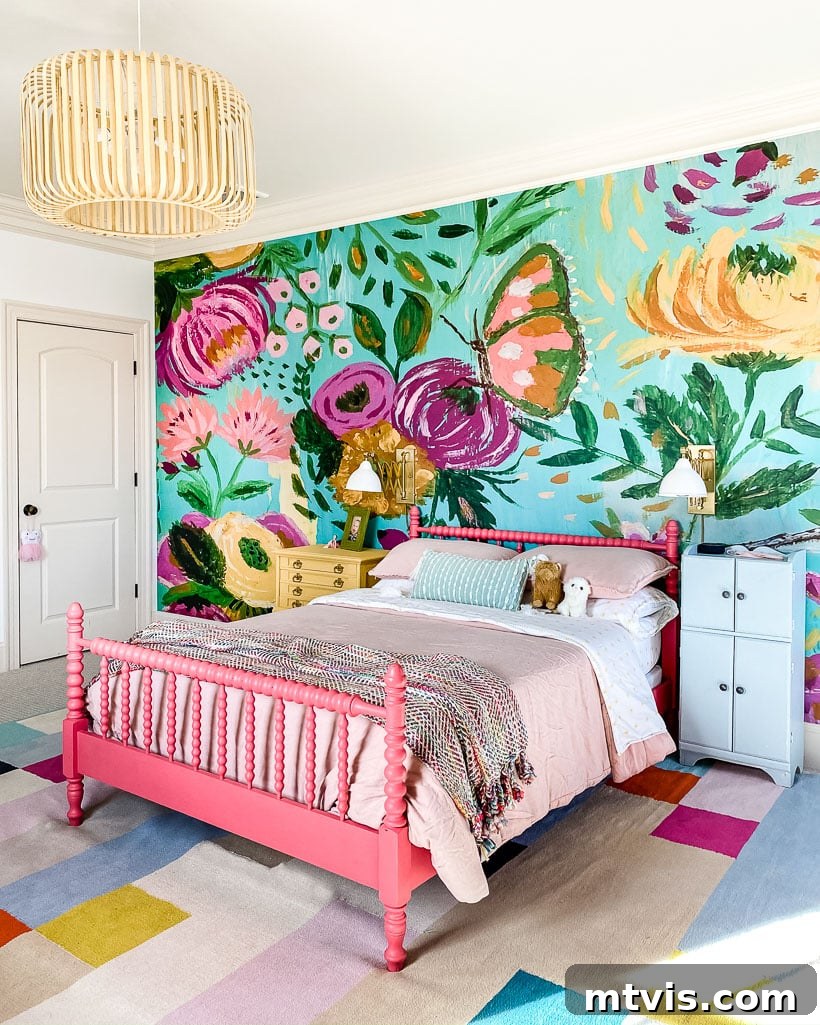 Perfecting Your Bedroom: The Complete Rug Size and Placement Guide 4 A vibrant girl's bedroom showcasing an area rug laid over existing carpet, complementing a striking wall mural.