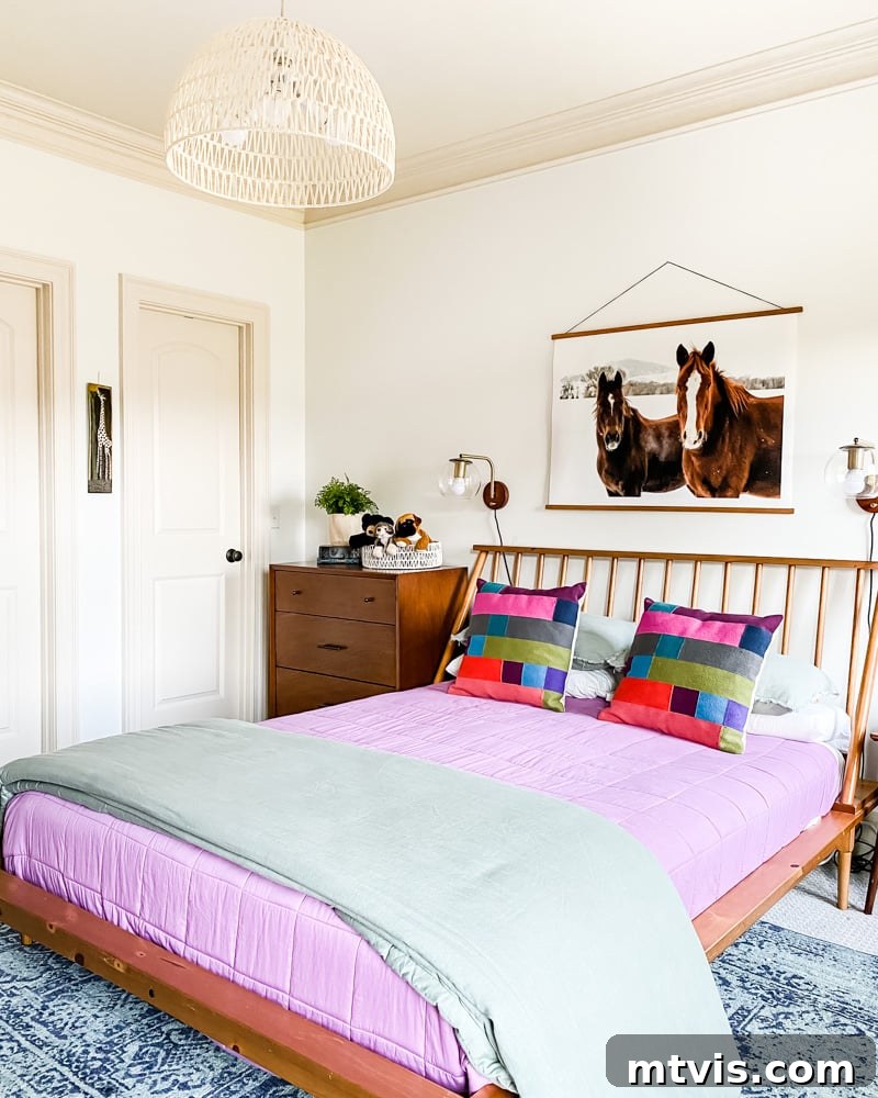 Perfecting Your Bedroom: The Complete Rug Size and Placement Guide 9 A modern girl's bedroom featuring an 8' x 10' rug elegantly placed under a queen-size bed, layered over carpet for added style and comfort.