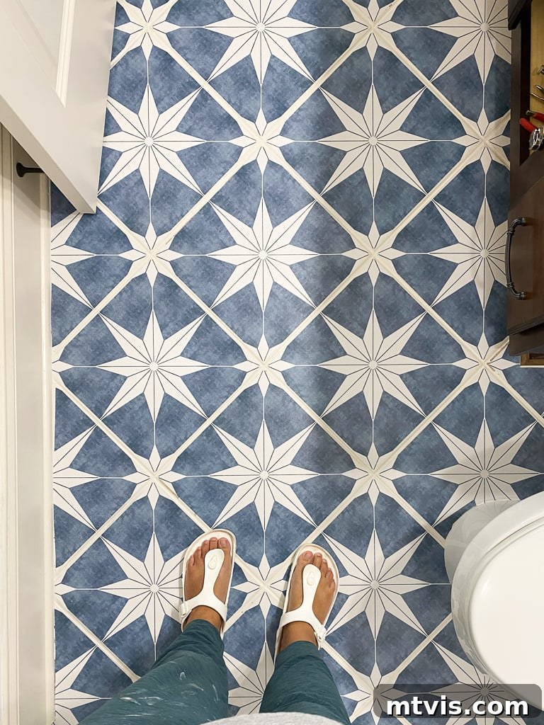 Stylish vinyl floor tile stickers enhancing the aesthetic of a modern bathroom.