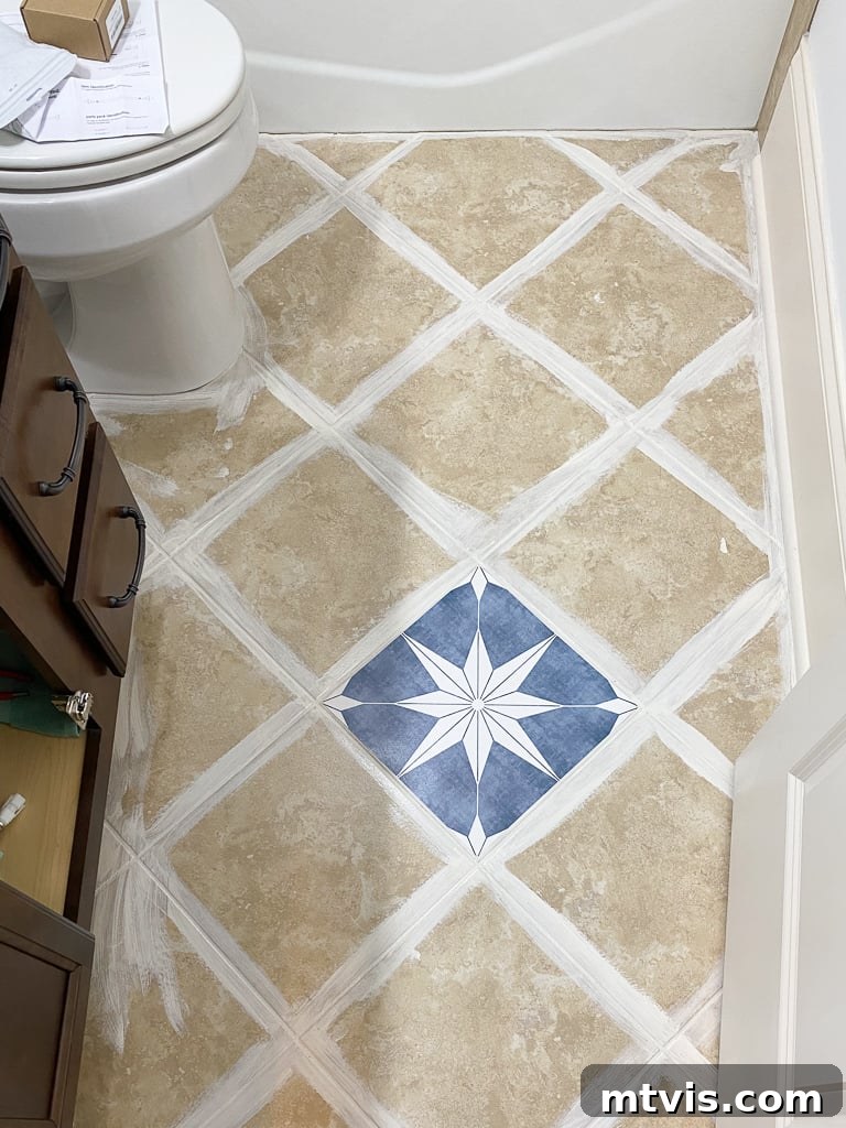 A person carefully installing tile stickers on a bathroom floor, showing the clean and prepared surface.
