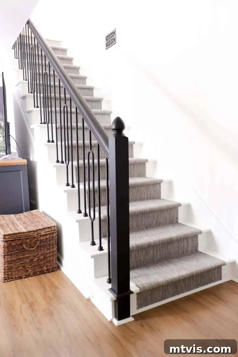 DIY staircase with makeover featuring modern spindles and grey indoor-outdoor runner