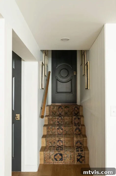 basement stair makeover with runner, dark doors, and modern accents