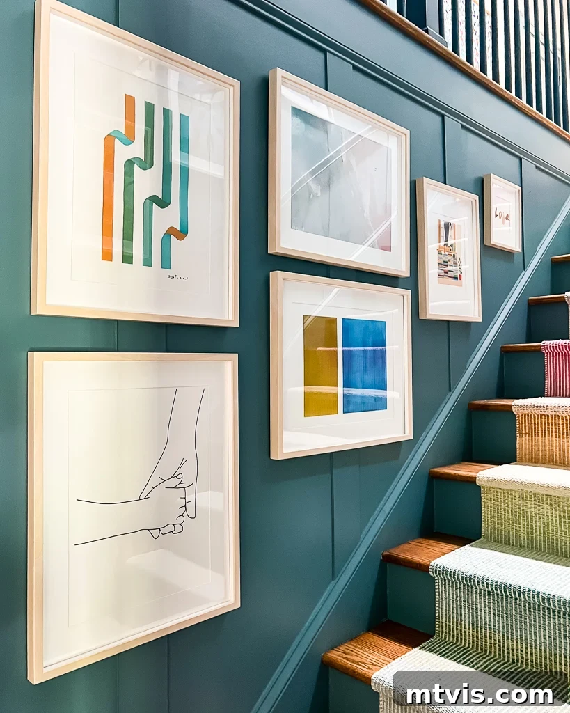 staircase gallery wall with colorful frames and art