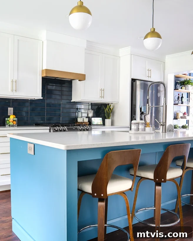 Elevate Your Kitchen with Timeless Neutral Cabinet Shades 4 Sherwin Williams Pure White kitchen cabinets with Silken Peacock blue island