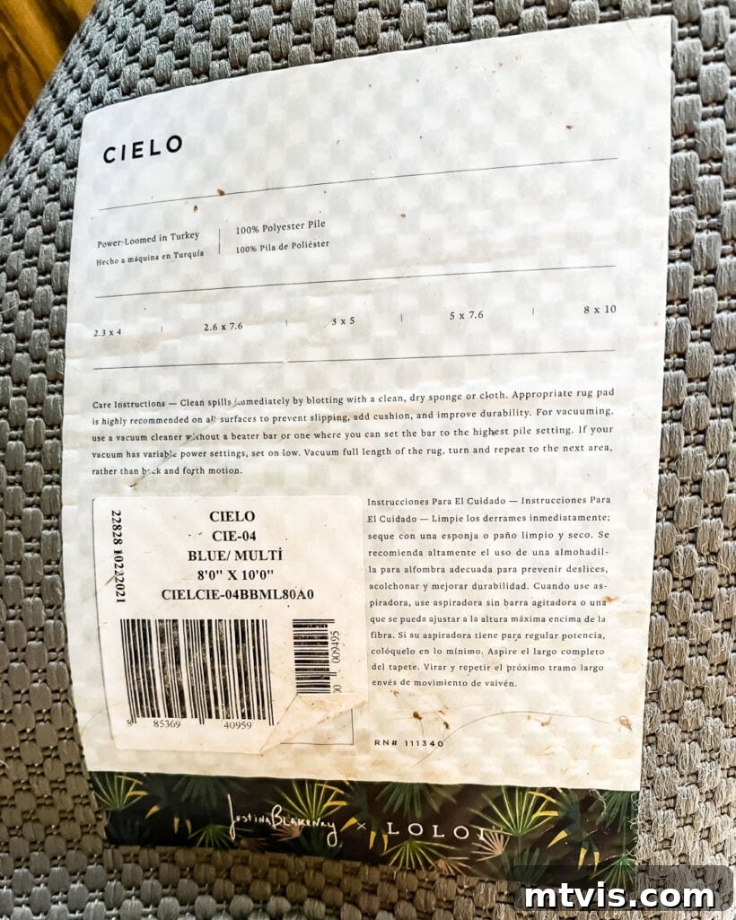 Close-up of an area rug's label showing material composition and cleaning instructions.